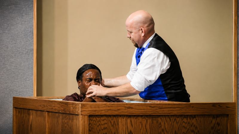 A believer being baptized